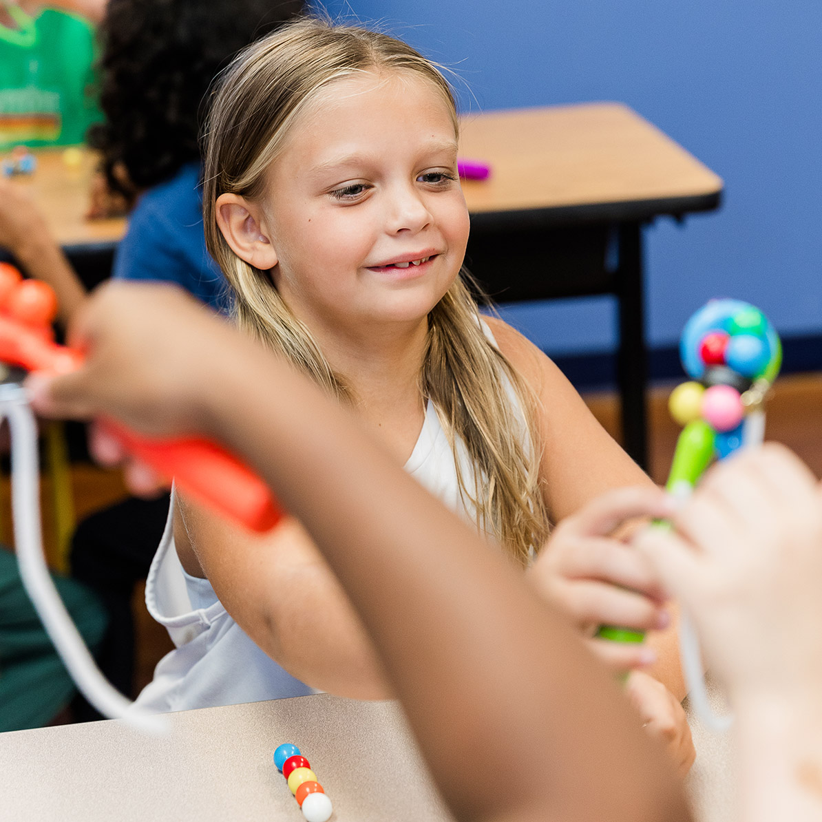 Elementary student performing a science experiment in class