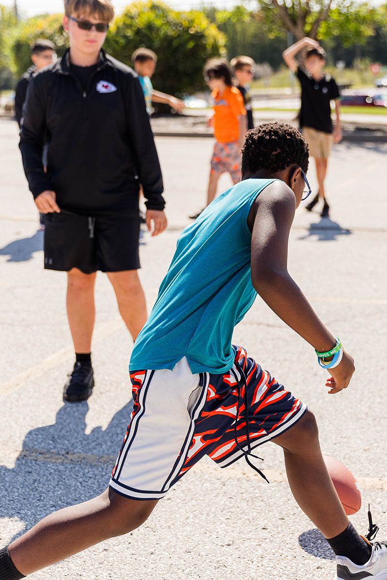 Middle school students playing basketball outside
