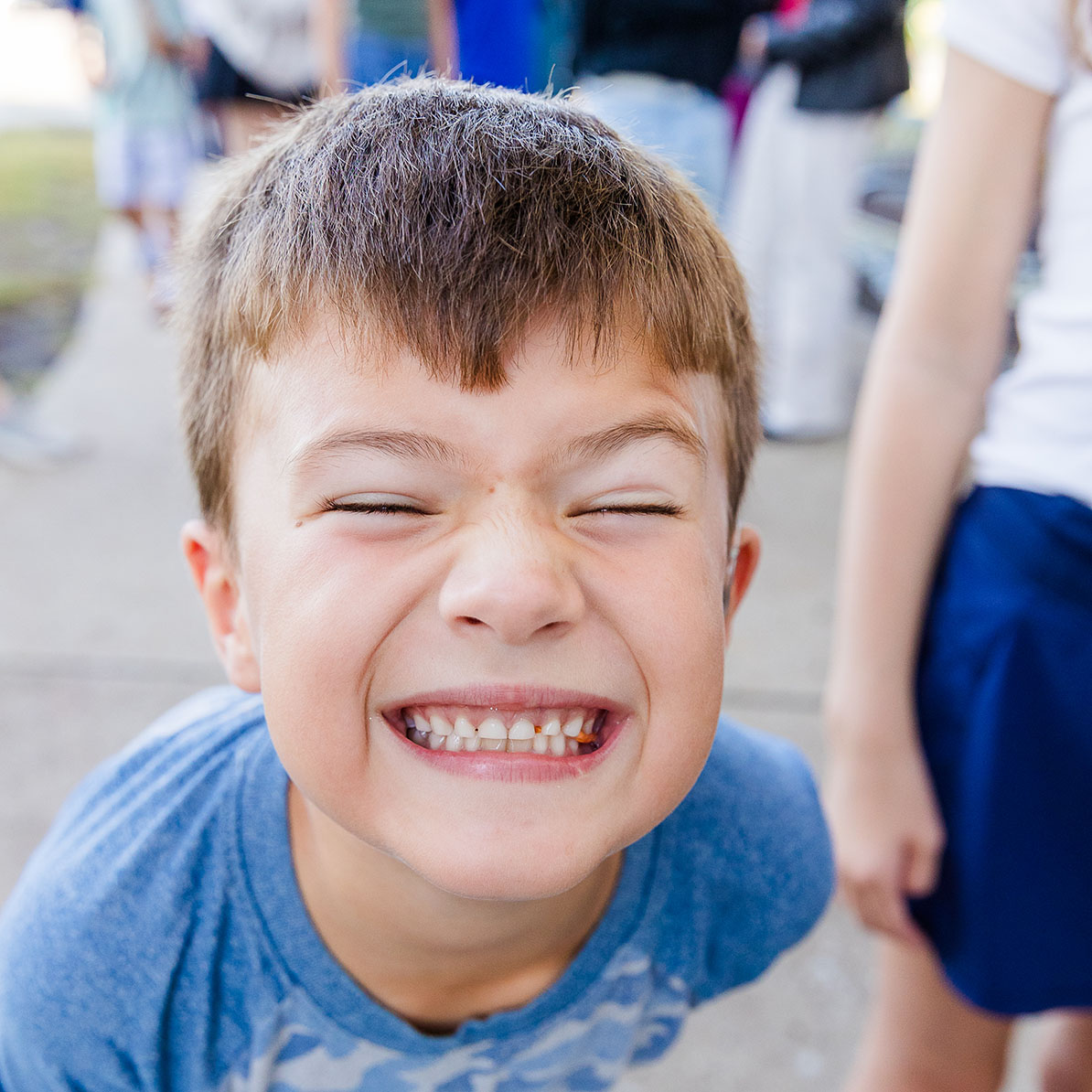 CALE student smiling as big as possible with face close to the camera