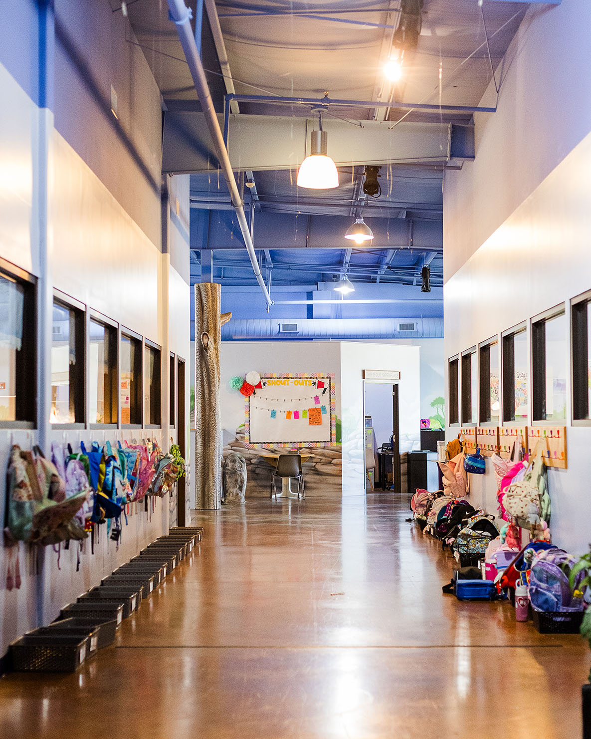 Looking down a hallway lined with student backpacks