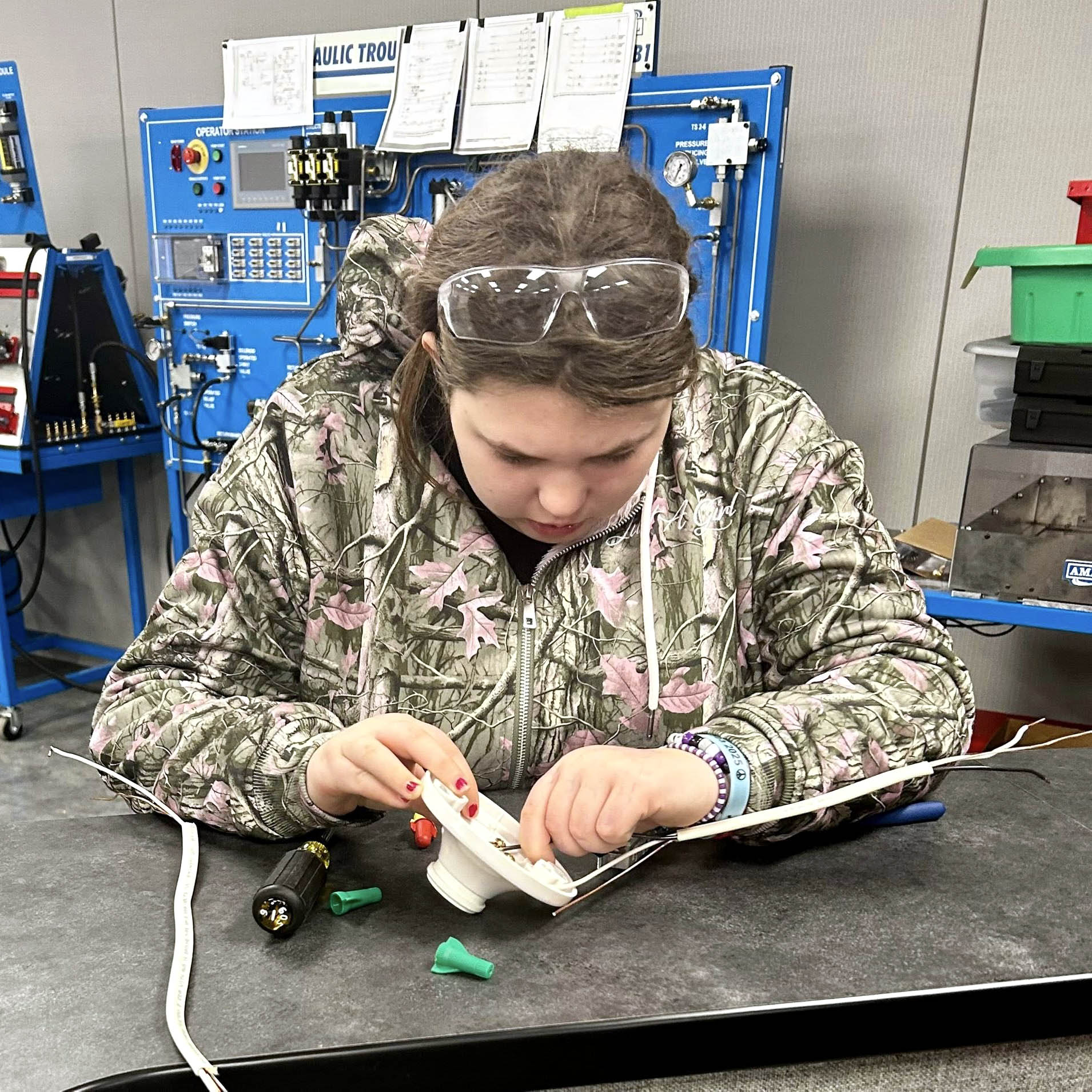 High school student wiring a speaker together