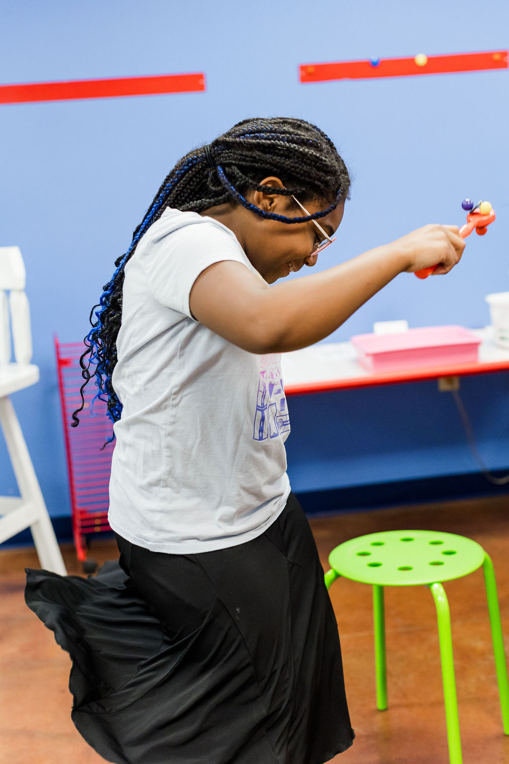 Student standing while performing a science experiment