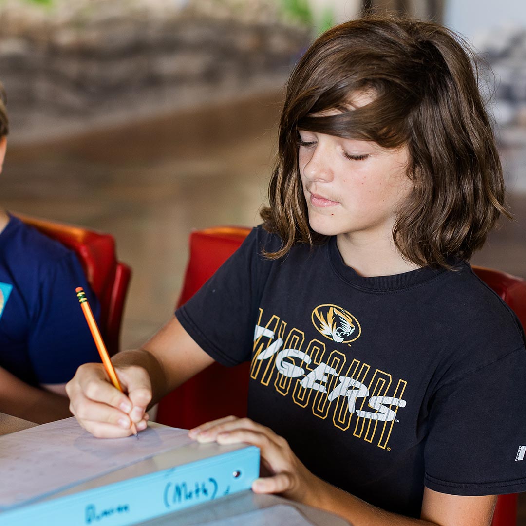 Middle school student working on a math worksheet
