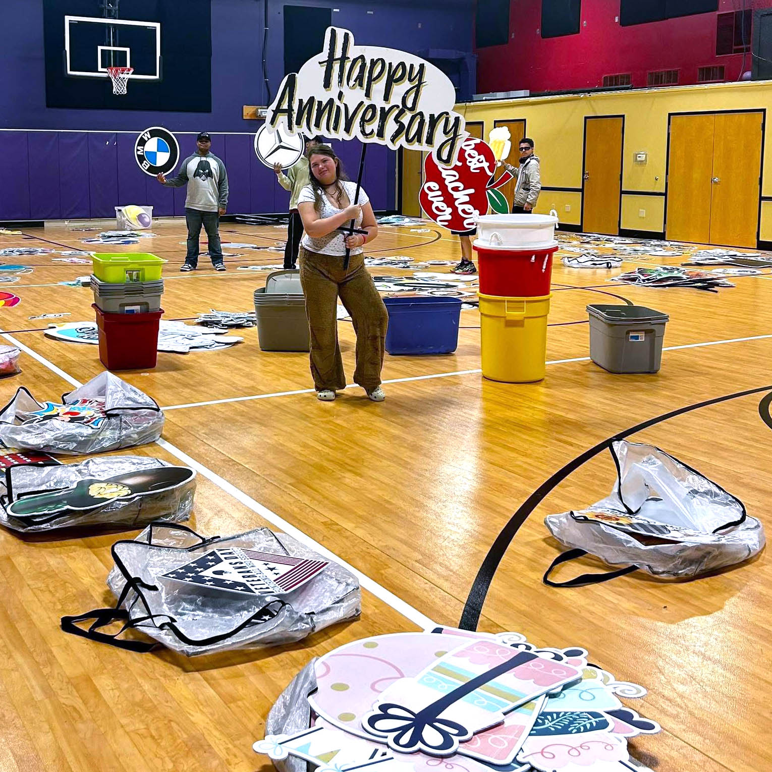High school students organizing props in the gym